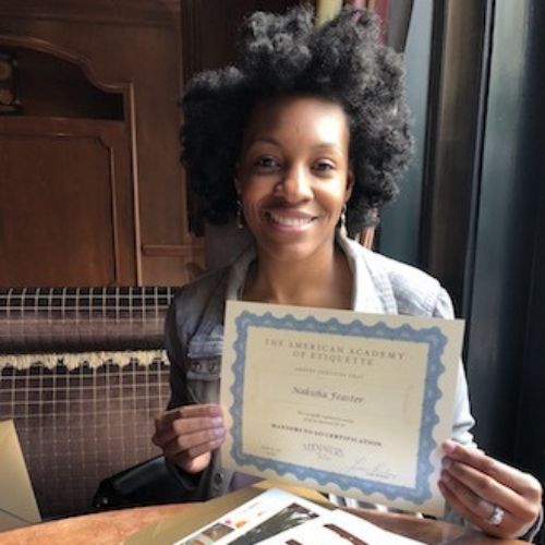 A children's manners licensee show her certificate from The American Academy of Etiquette