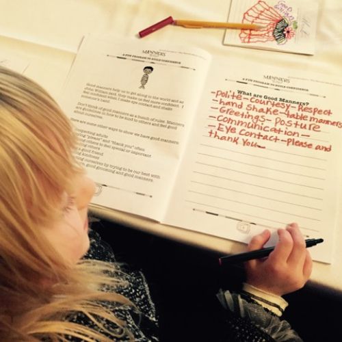 A young girl working on a Good Manners lesson.