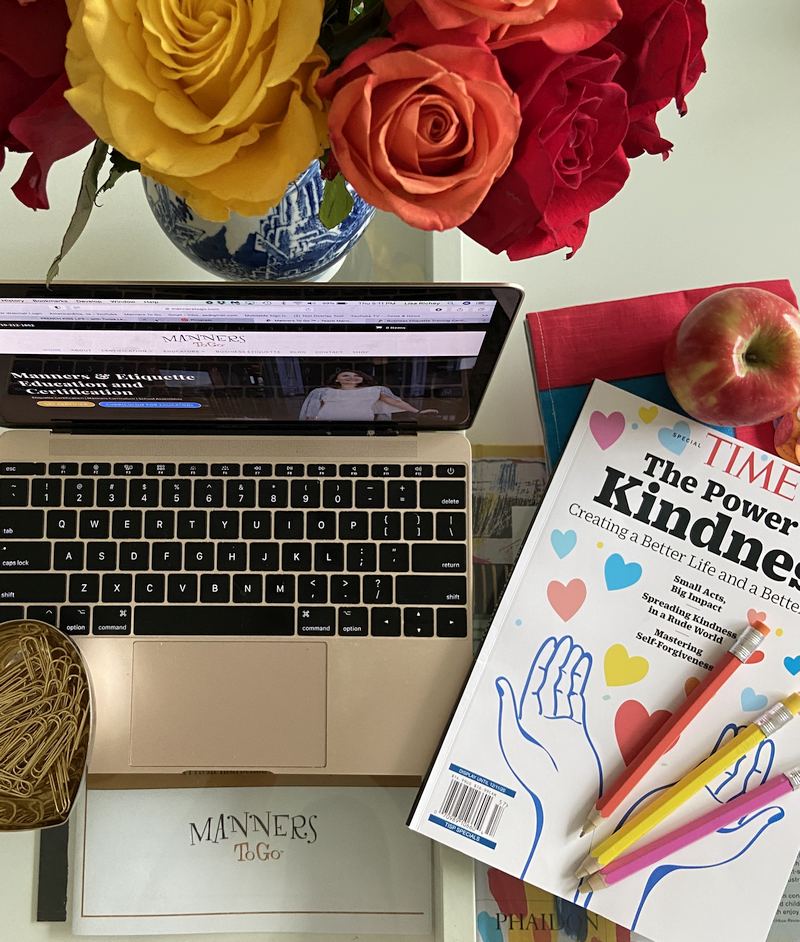 Lisa Richey website and a time magazine on a table top with flowers